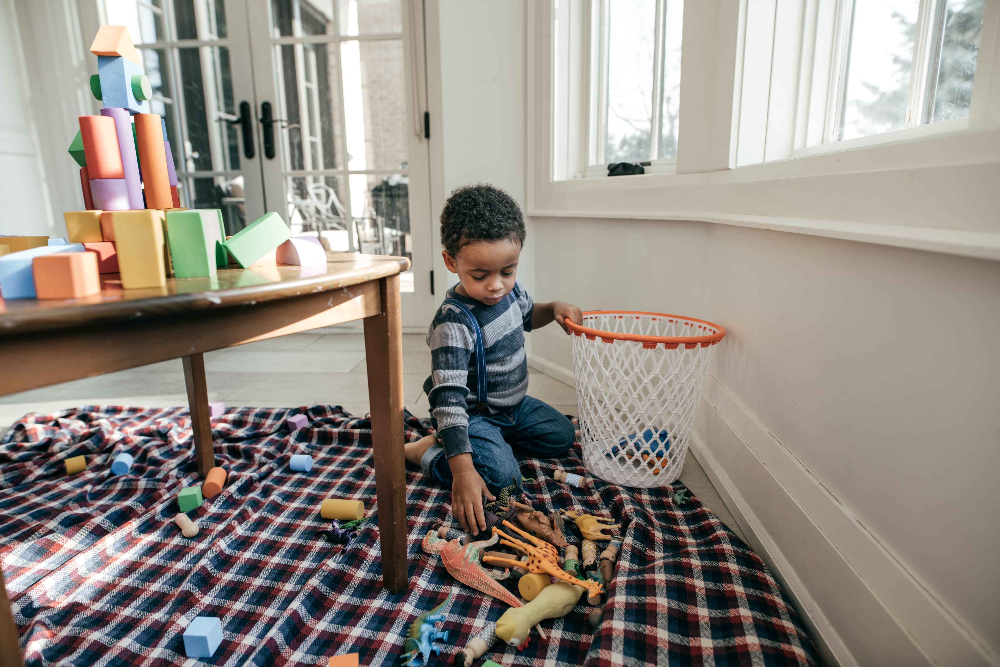 Child picking up his toys