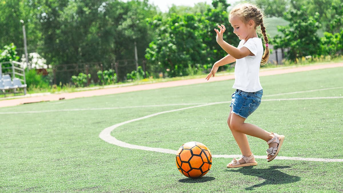 Preschooler playing with a ball.
