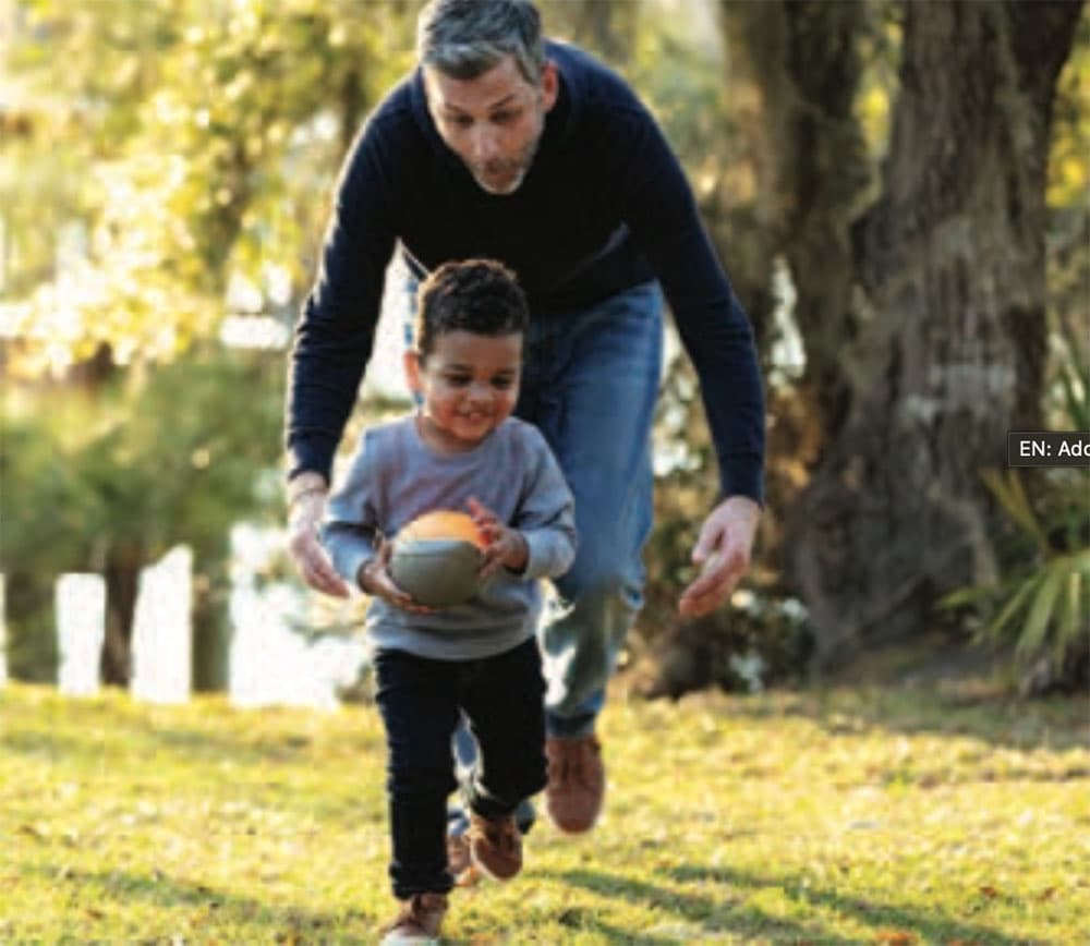 Father and son playing with a ball
