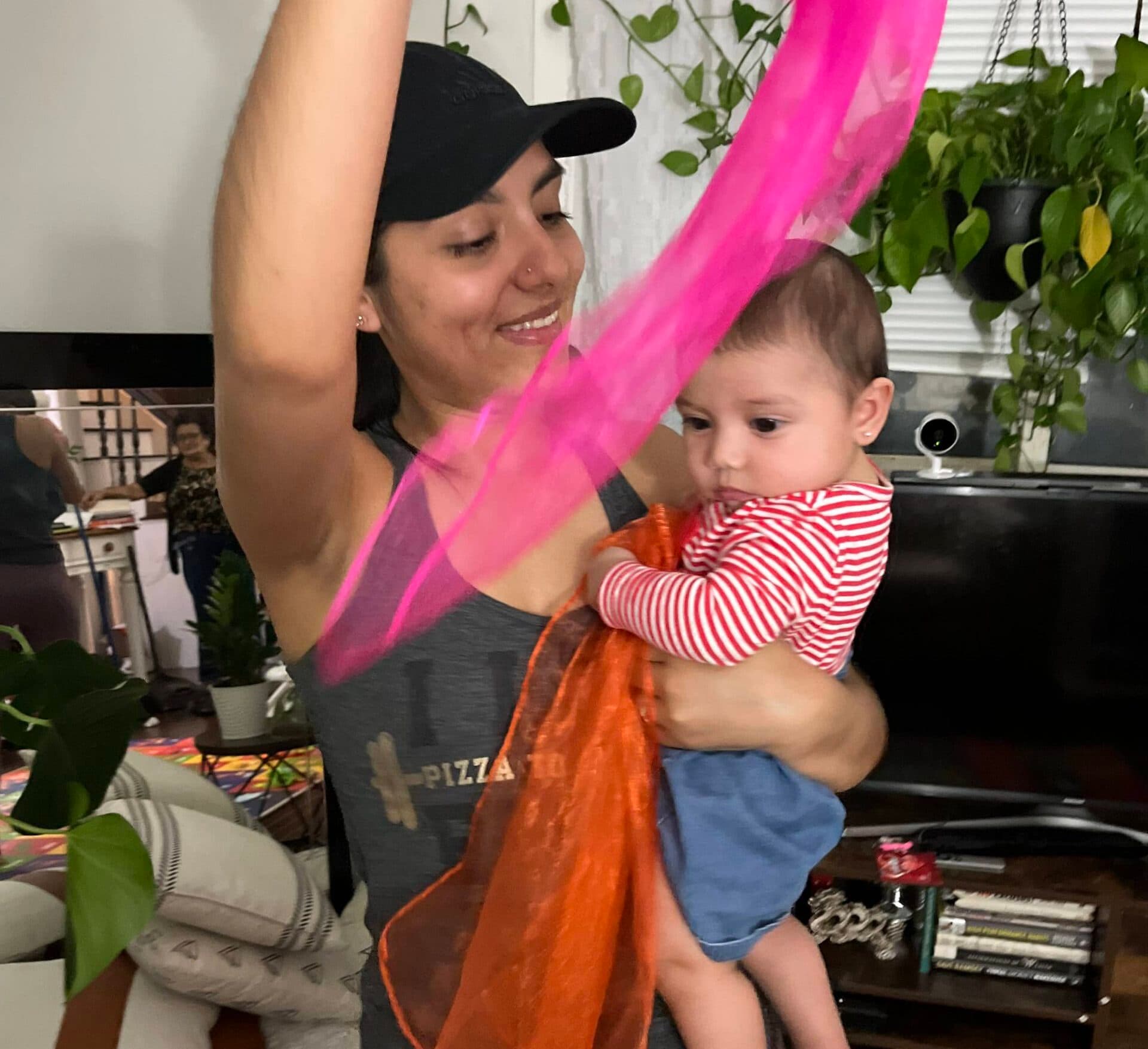 woman and baby playing with scarf