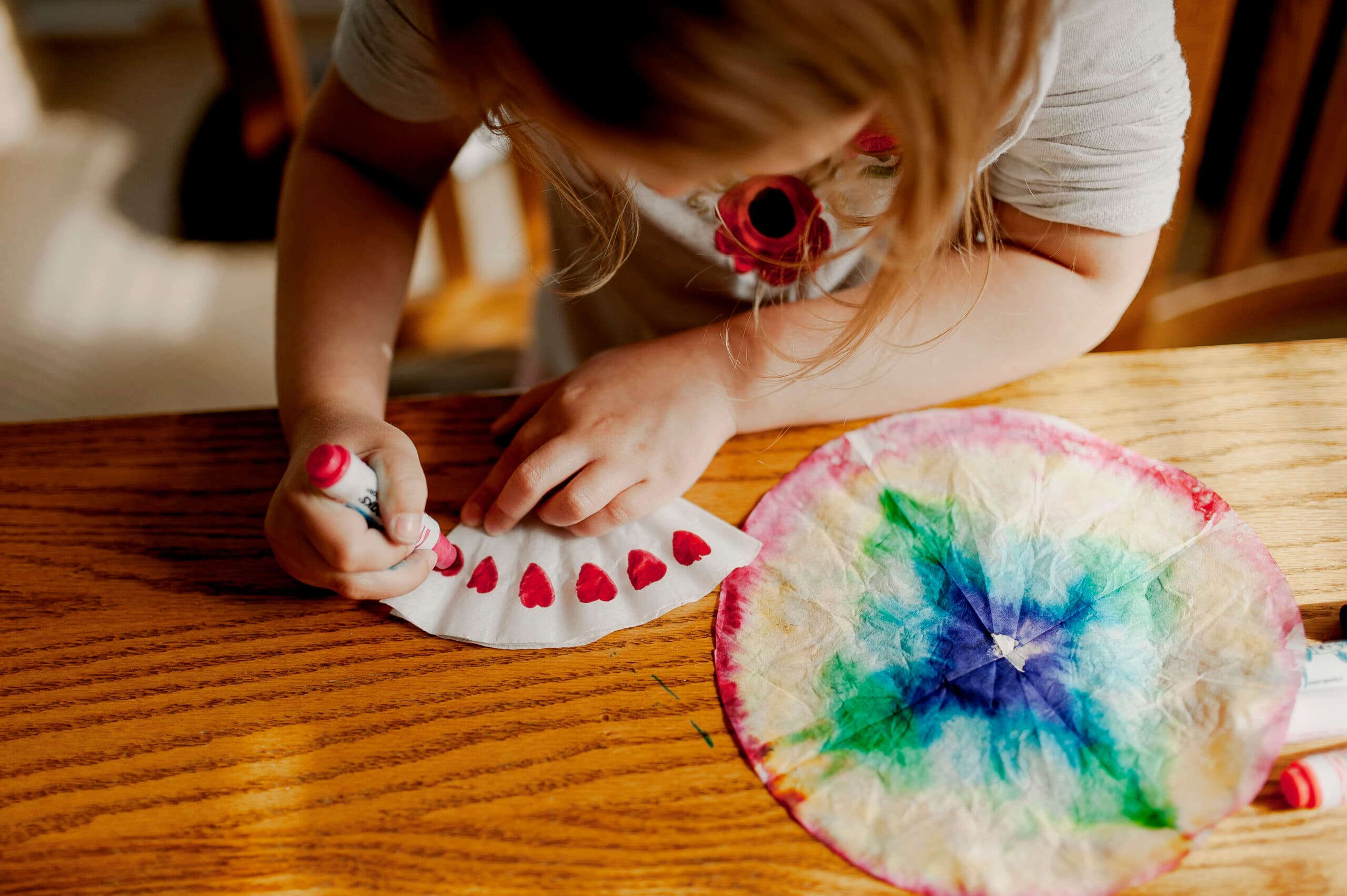girl creating coffee filter art