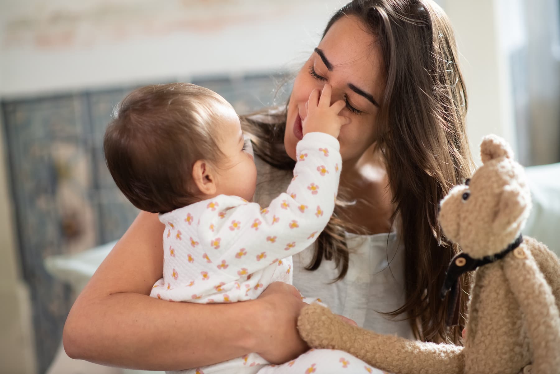 Baby boy touching mother's face