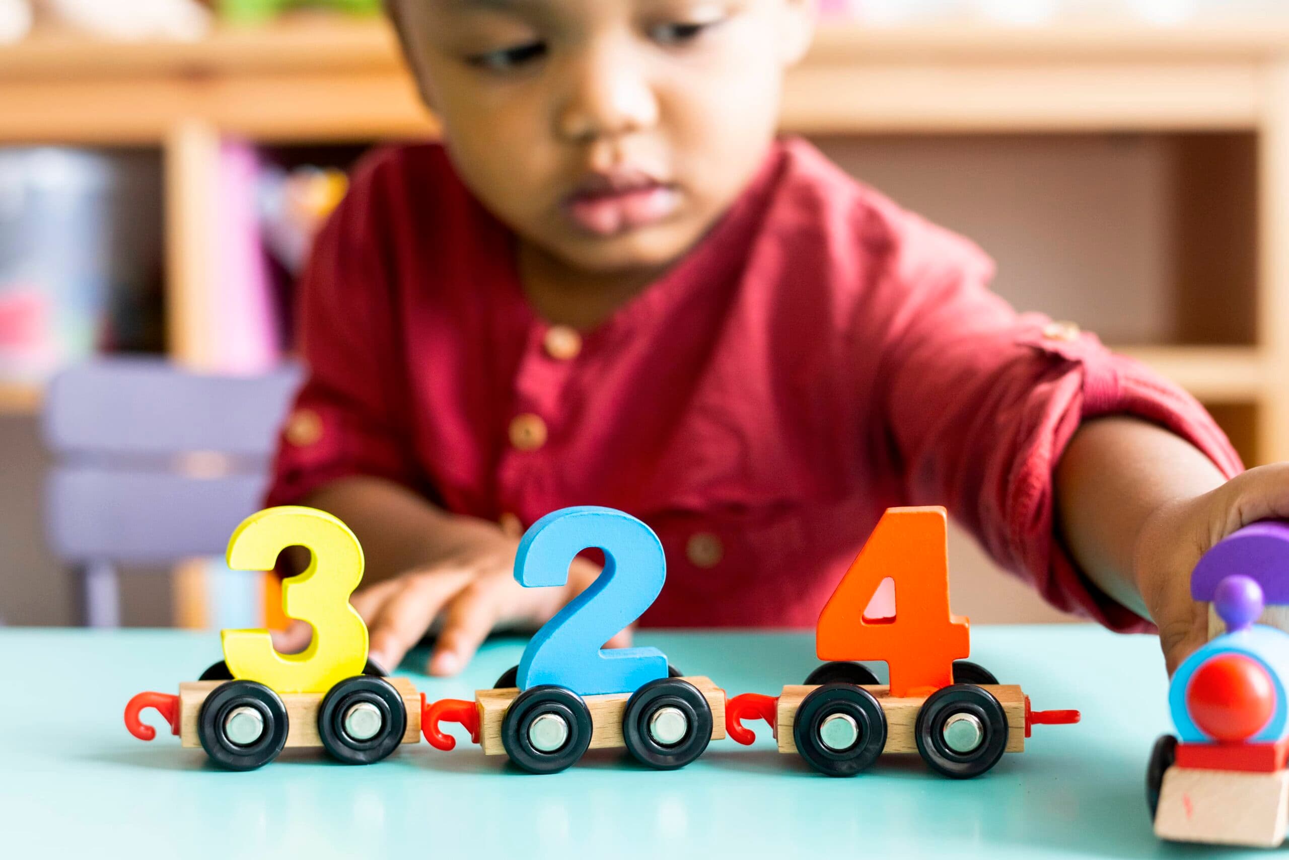 child plays with number trains